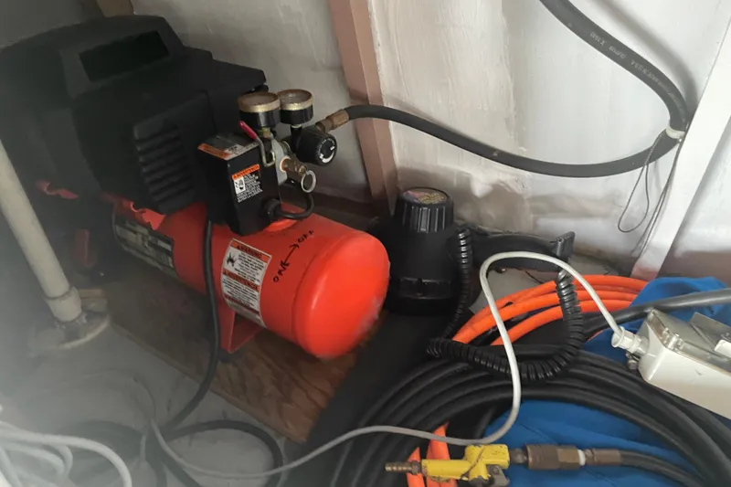 Slide: The Image of Air compressor setup on 1978 Delta Marine 43 Trawler, featuring hoses and gauges. - 11