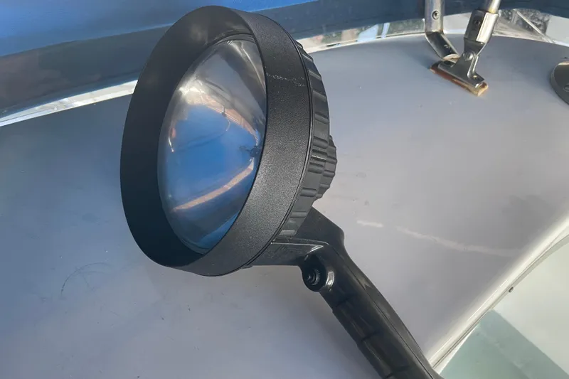 Slide: The Image of Handheld spotlight on Delta Marine 43 Trawler, 1978 model, resting on a boat surface. - 14