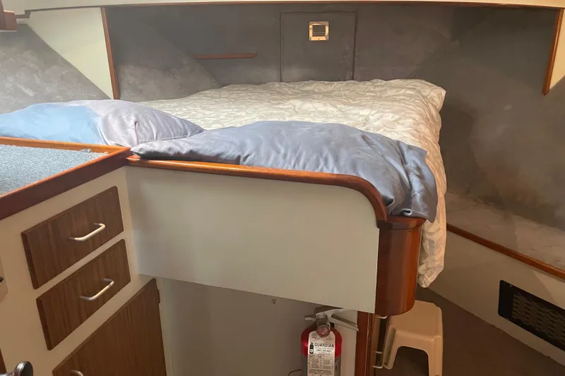 Slide: The Image of 1978 Delta Marine 43 Trawler cabin with bed, drawers, and fire extinguisher. - 16