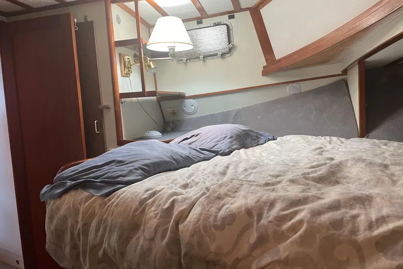 Slide: The Image of Cozy cabin interior of 1978 Delta Marine 43 Trawler with bed and wooden accents. - 17