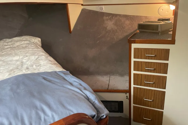 Slide: The Image of Cozy cabin interior of 1978 Delta Marine 43 Trawler with bed and wooden drawers. - 19