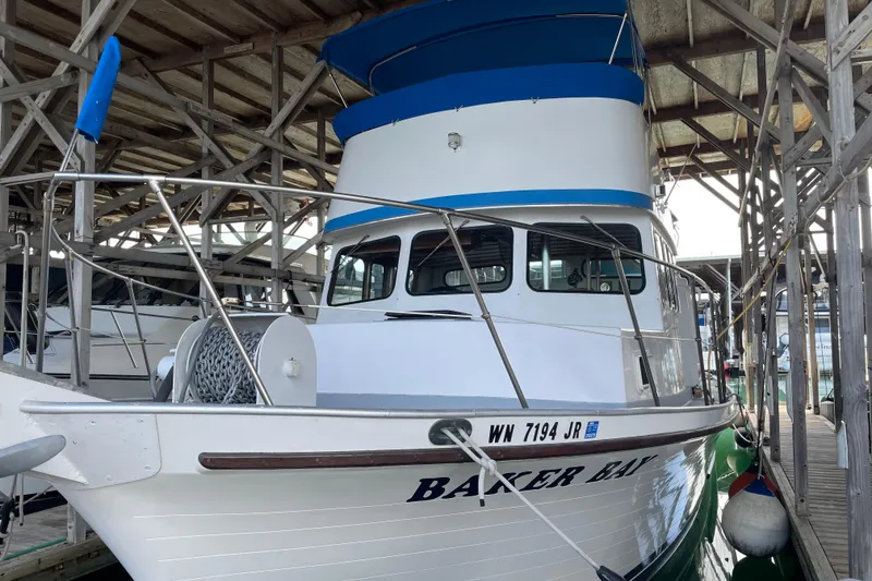 Slide: The Image of 1978 Deltamar 43 Marine boat docked in a wooden marina. - 2