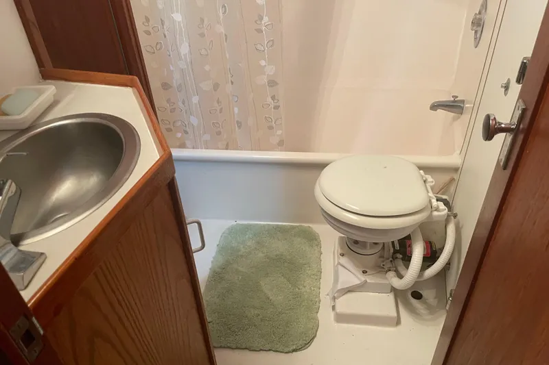 Slide: The Image of Bathroom interior of 1978 Delta Marine 43 Trawler with sink, toilet, and shower. - 21