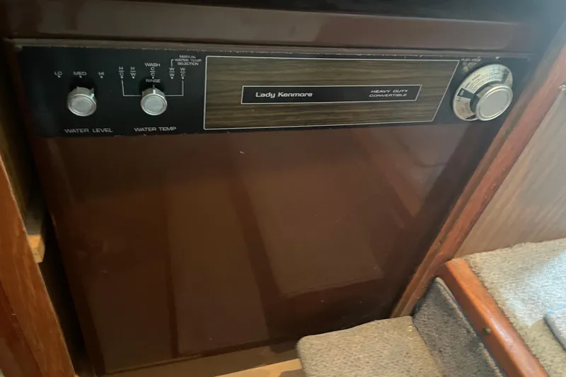 Slide: The Image of Vintage Lady Kenmore appliance on 1978 Delta Marine 43 Trawler, featuring control knobs and settings. - 22
