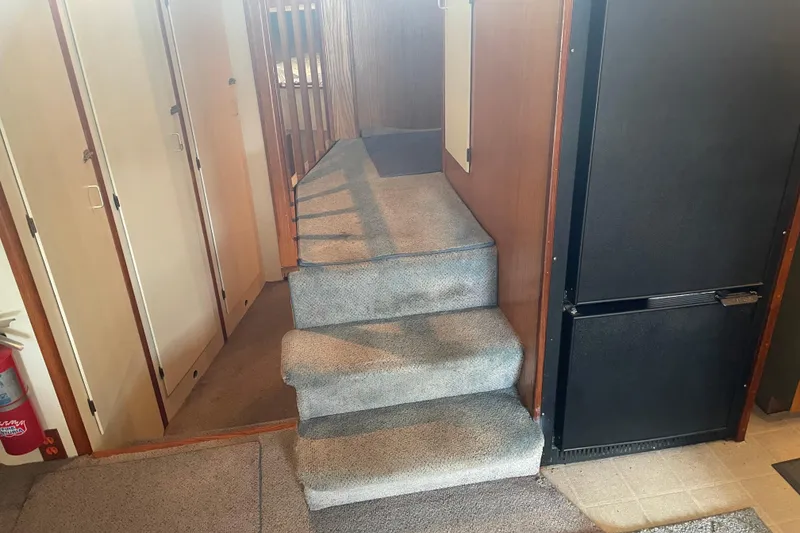 Slide: The Image of Interior of 1978 Delta Marine 43 Trawler with carpeted stairs and wooden paneling. - 23