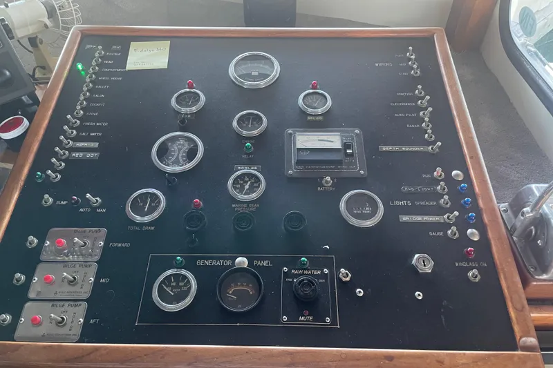 Slide: The Image of Control panel of a 1978 Delta Marine 43 Trawler with various gauges and switches. - 34