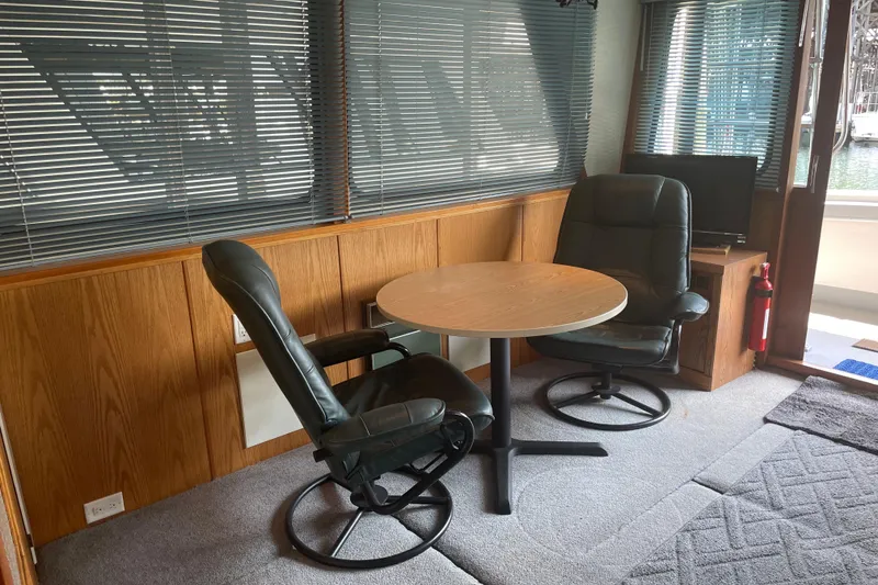 Slide: The Image of Interior of 1978 Delta Marine 43 Trawler with chairs, table, and window blinds. - 41