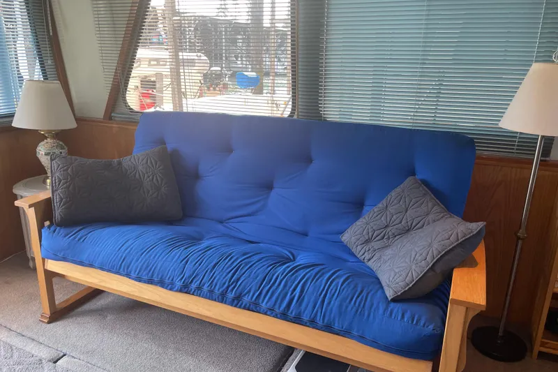 Slide: The Image of Blue futon with gray pillows inside a 1978 Delta Marine 43 Trawler. - 42