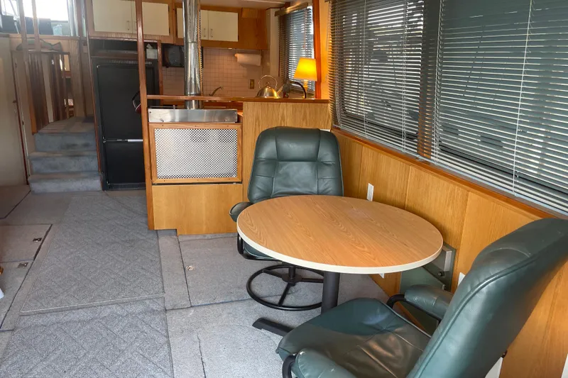 Slide: The Image of Interior of 1978 Delta Marine 43 Trawler with seating, table, and kitchenette. - 43