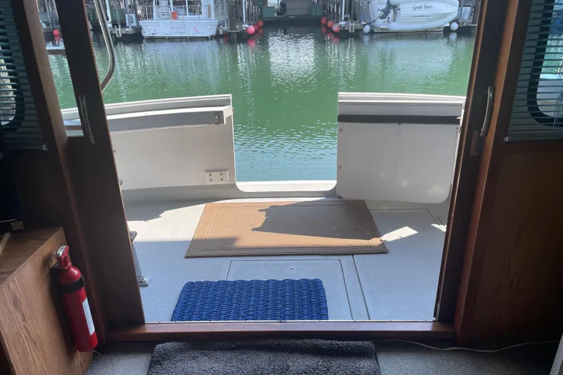 Slide: The Image of Interior view of 1978 Delta Marine 43 Trawler, open door to marina. - 47