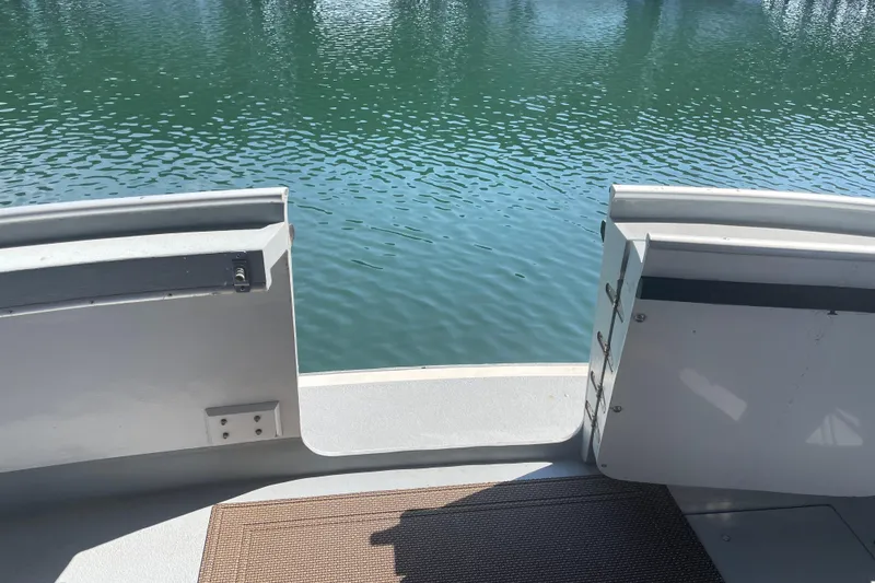 Slide: The Image of Open gate on 1978 Delta Marine 43 Trawler overlooking calm water. - 48