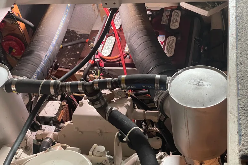 Slide: The Image of Engine room of a 1978 Delta Marine 43 Trawler with visible hoses and components. - 59