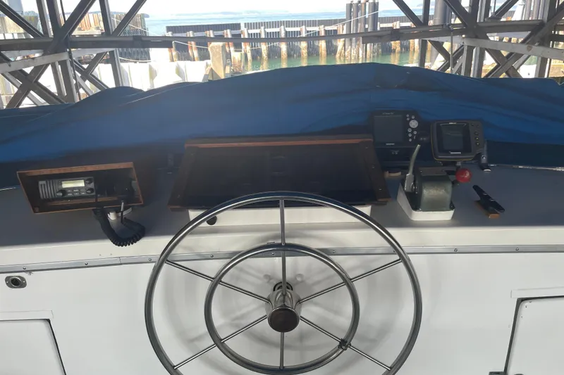Slide: The Image of 1978 Delta Marine 43 Trawler helm with navigation equipment and steering wheel. - 7