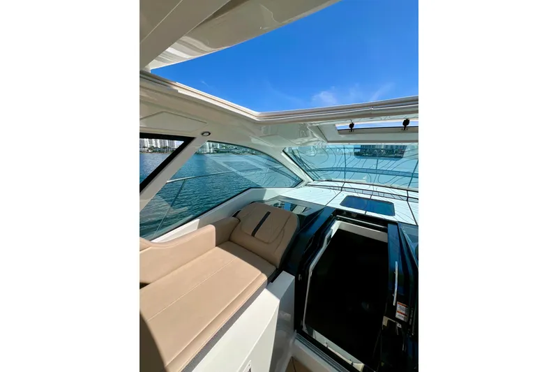Slide: The Image of 2017 Sea Ray Sundancer 350 Coupe interior with sunroof and waterfront view. - 11