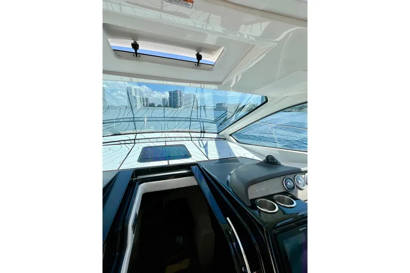 Slide: The Image of Interior view of 2017 Sea Ray Sundancer 350 Coupe with cityscape and water in background. - 17