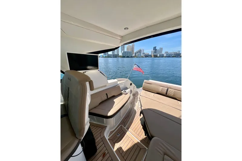 Slide: The Image of 2017 Sea Ray Sundancer 350 Coupe interior with city skyline and water view. - 18