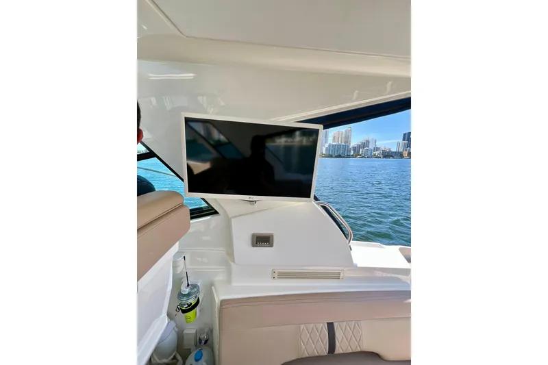 Slide: The Image of Interior of 2017 Sea Ray Sundancer 350 Coupe with TV and waterfront view. - 22
