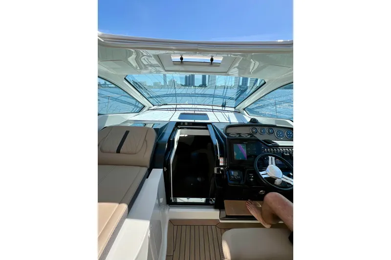 Slide: The Image of Interior view of 2017 Sea Ray Sundancer 350 Coupe yacht cockpit with modern controls. - 24