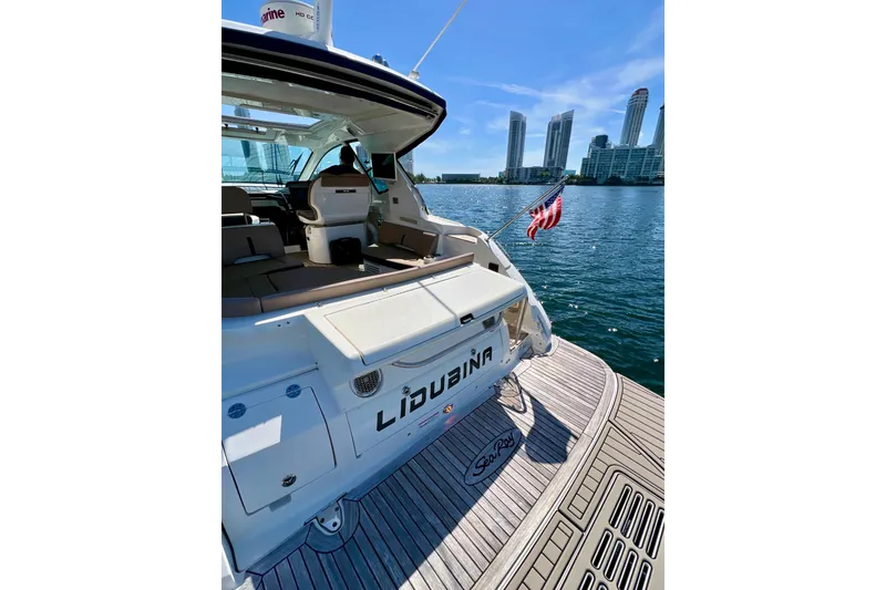 Slide: The Image of 2017 Sea Ray Sundancer 350 Coupe yacht docked with city skyline in background. - 25