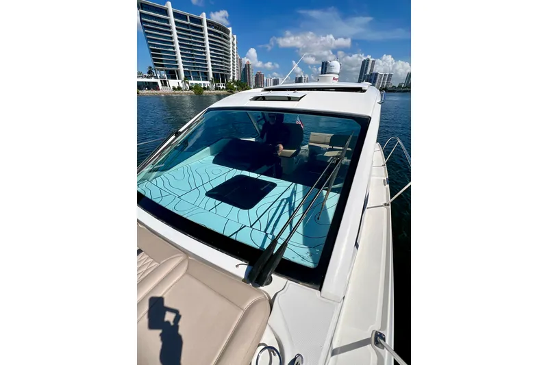Slide: The Image of 2017 Sea Ray Sundancer 350 Coupe on water, city skyline in background. - 27
