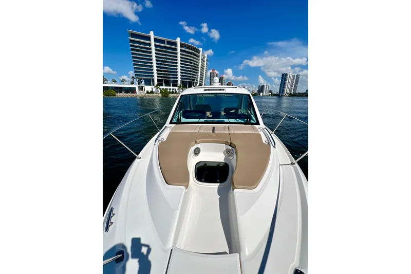Slide: The Image of 2017 Sea Ray Sundancer 350 Coupe on water, city skyline in background. - 28