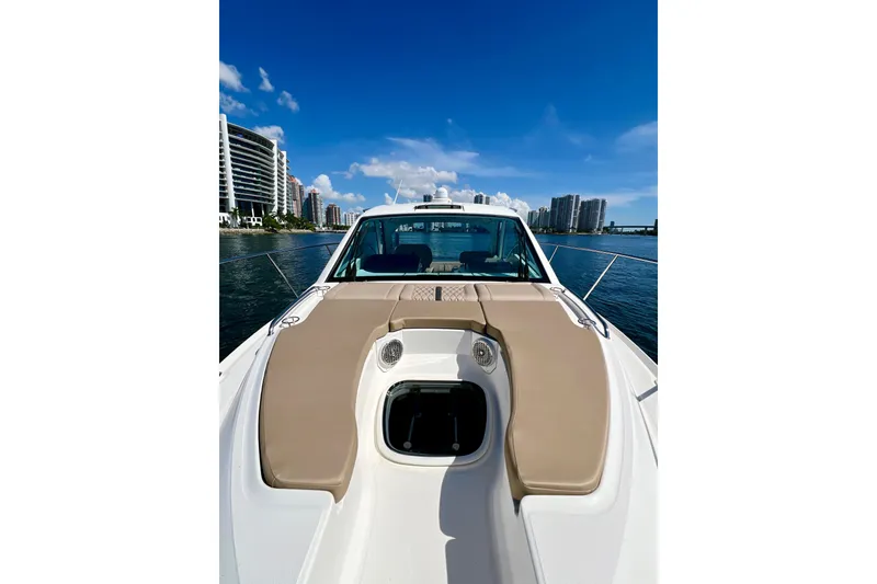 Slide: The Image of 2017 Sea Ray Sundancer 350 Coupe on water, city skyline in background. - 29