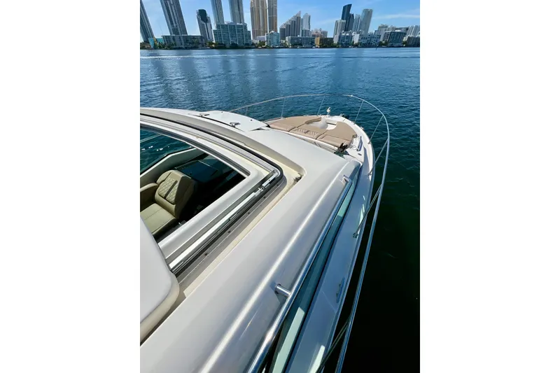 Slide: The Image of 2017 Sea Ray Sundancer 350 Coupe on water with city skyline background. - 30