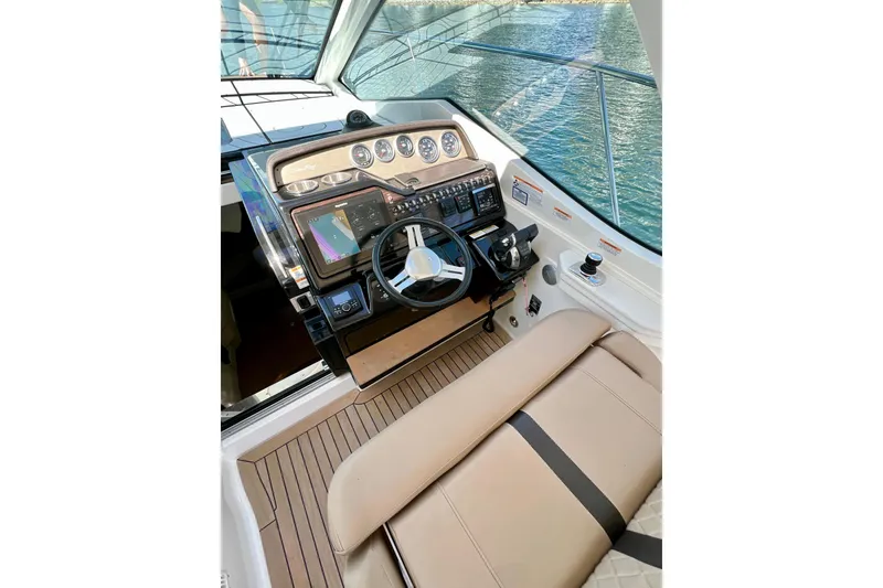 Slide: The Image of 2017 Sea Ray Sundancer 350 Coupe helm with modern controls and navigation system. - 34