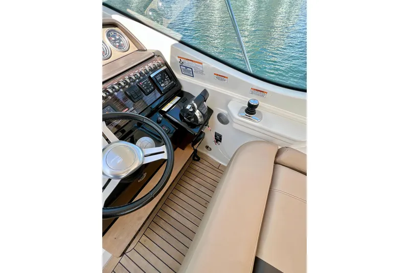 Slide: The Image of 2017 Sea Ray Sundancer 350 Coupe helm with steering wheel and control panel. - 35