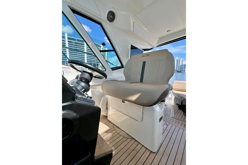 Slide: The Image of 2017 Sea Ray Sundancer 350 Coupe helm with luxurious seating and modern controls. - 40