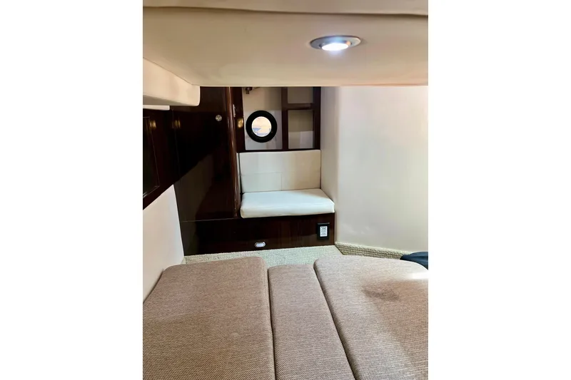 Slide: The Image of 2017 Sea Ray Sundancer 350 Coupe interior cabin with seating and porthole. - 49