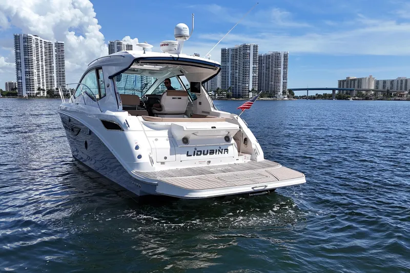 Slide: The Image of 2017 Sea Ray Sundancer 350 Coupe on water, city skyline in background. - 5