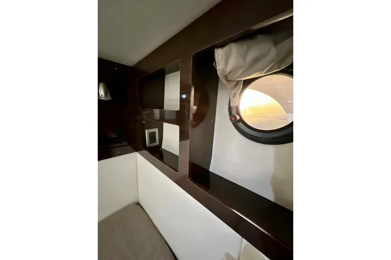 Slide: The Image of Interior of 2017 Sea Ray Sundancer 350 Coupe with porthole and shelving. - 50