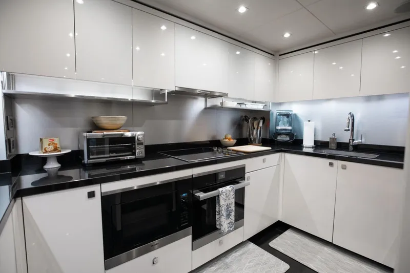 Slide: The Image of Luxurious kitchen interior on a 2018 Sunseeker 95 Yacht, featuring modern appliances and sleek design. - 16