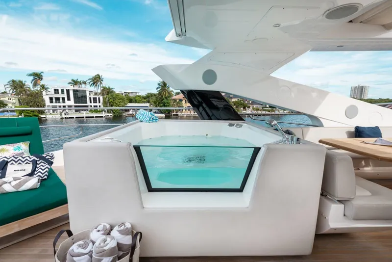 Slide: The Image of Luxurious 2018 Sunseeker 95 Yacht with jacuzzi on deck, overlooking waterfront homes. - 20