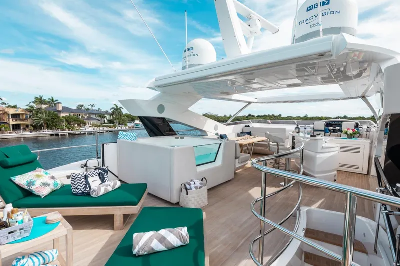 Slide: The Image of Luxurious 2018 Sunseeker 95 Yacht deck with elegant seating and scenic waterfront view. - 27