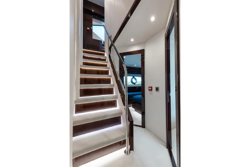 Slide: The Image of Luxurious interior staircase of 2018 Sunseeker 95 Yacht, featuring elegant lighting and modern design. - 32