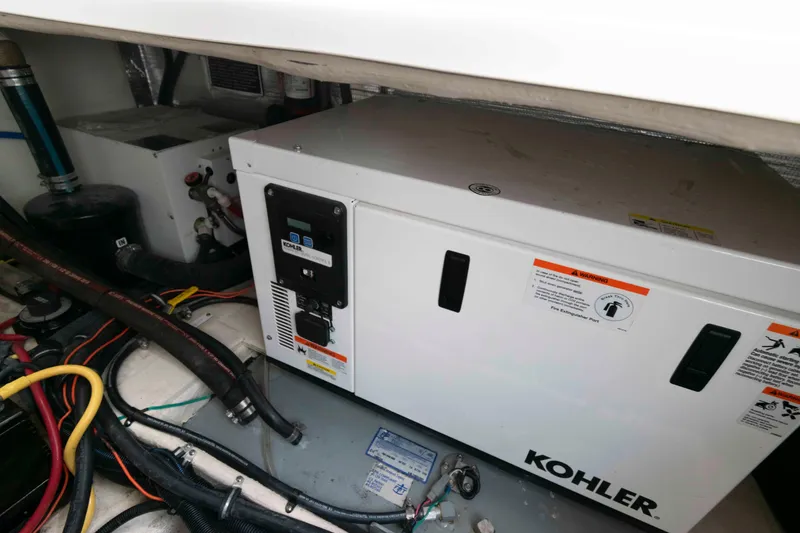 Slide: The Image of Engine compartment of 2019 Rinker 290 EX with Kohler generator and wiring. - 11