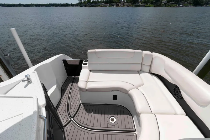 Slide: The Image of 2019 Rinker 290 EX boat with white seating and lake view. - 3