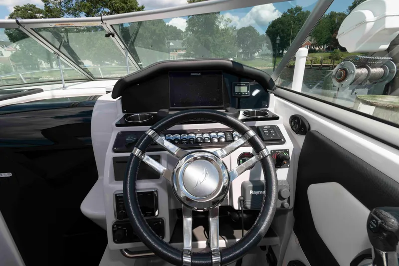 Slide: The Image of 2019 Rinker 290 EX boat helm with modern controls and navigation system. - 5