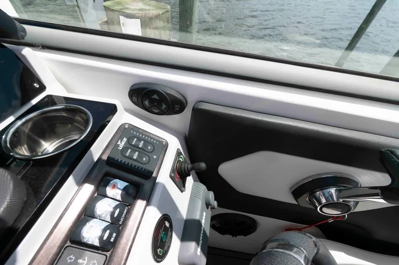 Slide: The Image of 2019 Rinker 290 EX boat cockpit with control panel and steering wheel. - 6