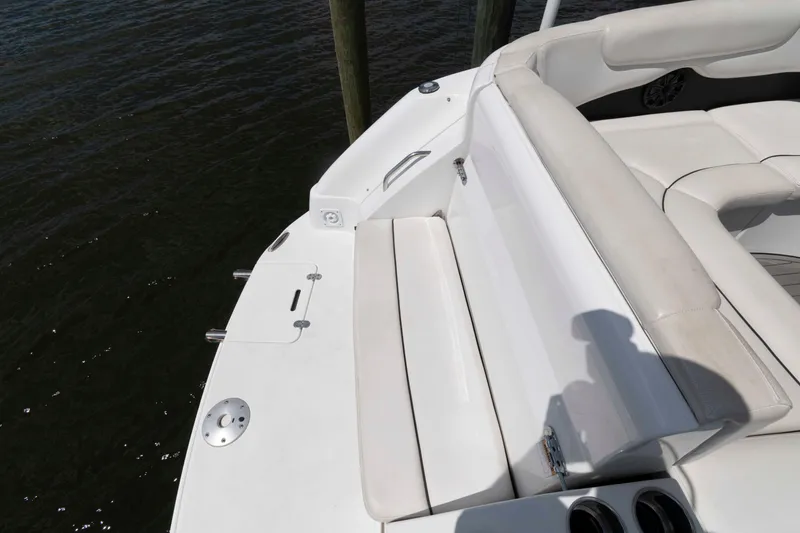 Slide: The Image of 2019 Rinker 290 EX boat interior with white seating and cup holders. - 8