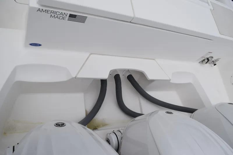 Slide: The Image of 2022 Pursuit OS 355 Offshore boat deck with engines, docked by the water. - 100