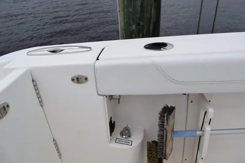 Slide: The Image of 2022 Pursuit OS 355 Offshore boat compartment with latch and warning label. - 140