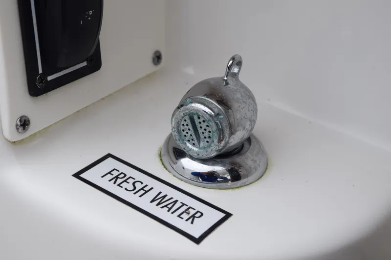 Slide: The Image of 2022 Pursuit OS 355 Offshore boat storage compartment with open hatch. - 142