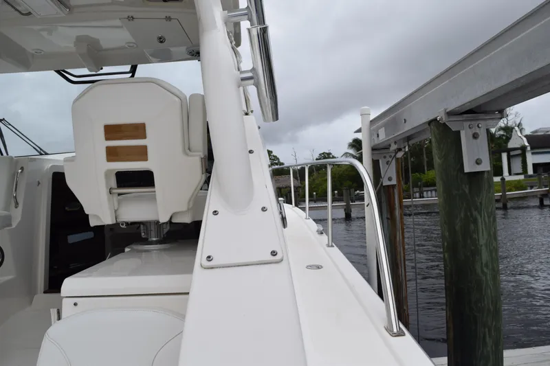 Slide: The Image of 2022 Pursuit OS 355 Offshore boat interior with white seating and storage area. - 186