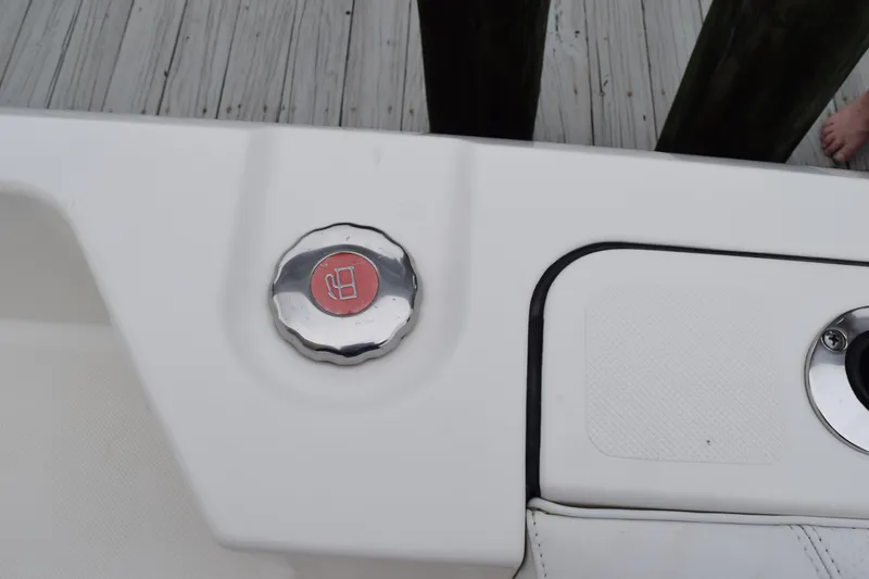 Slide: The Image of Compass on 2022 Pursuit OS 355 Offshore boat dashboard, with cloudy sky and marina view. - 216