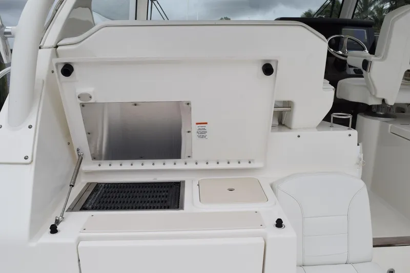 Slide: The Image of 2022 Pursuit OS 355 Offshore boat docked in a marina with cloudy skies. - 218