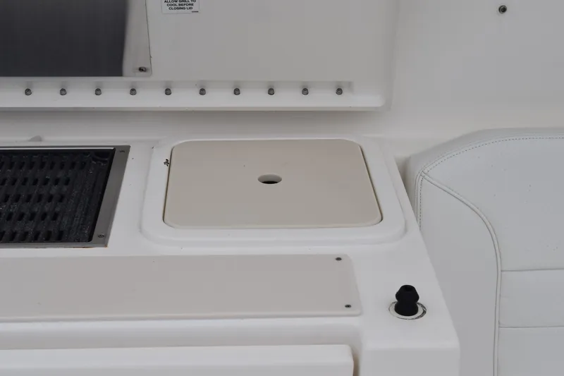 Slide: The Image of 2022 Pursuit OS 355 Offshore storage compartment with secure latch. - 220