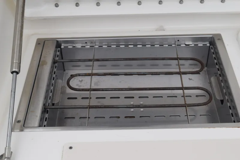 Slide: The Image of 2022 Pursuit OS 355 Offshore storage compartment with secure latch and speaker. - 222